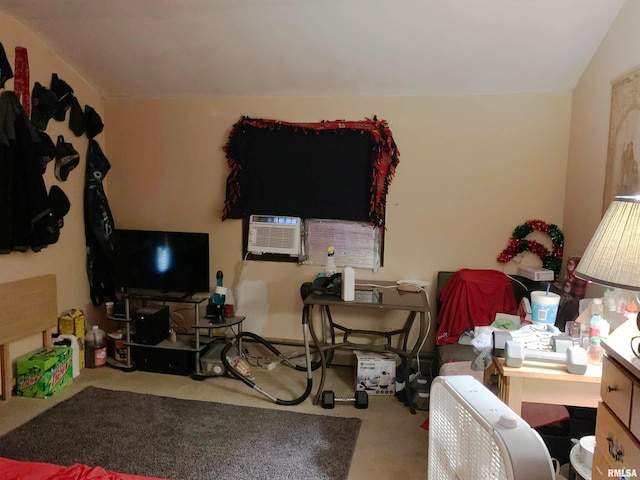 carpeted home office featuring vaulted ceiling