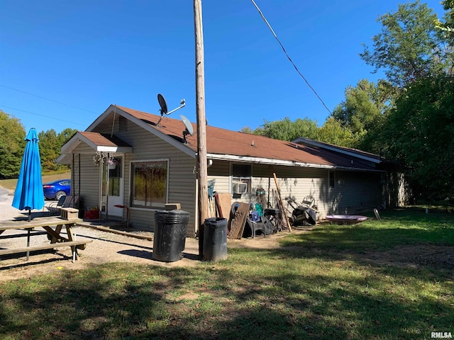 back of property with a lawn