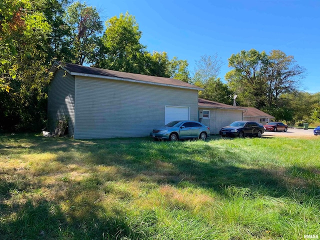 view of side of property with a garage and a yard