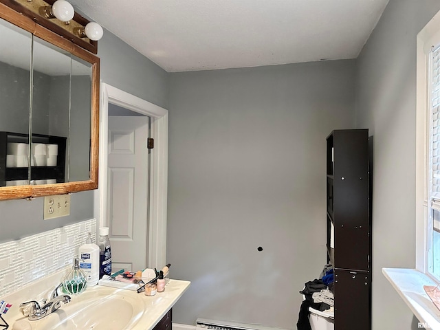 bathroom featuring tasteful backsplash and vanity