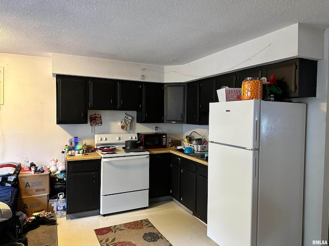 kitchen featuring white appliances and a textured ceiling