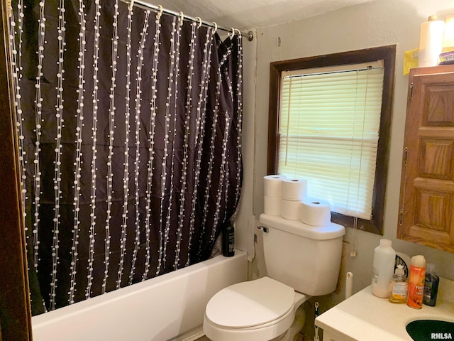 bathroom featuring shower / bathtub combination with curtain and toilet