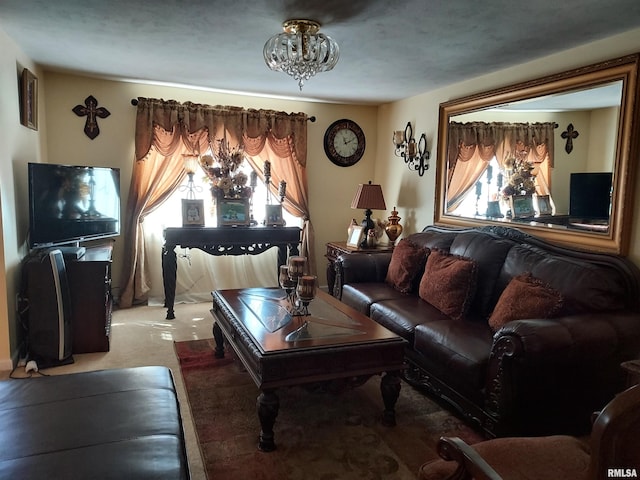 living room featuring carpet and an inviting chandelier