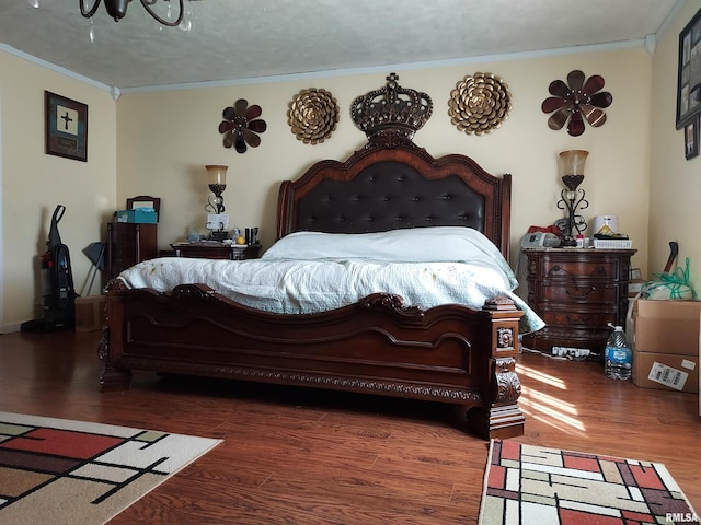 bedroom with ornamental molding and wood-type flooring