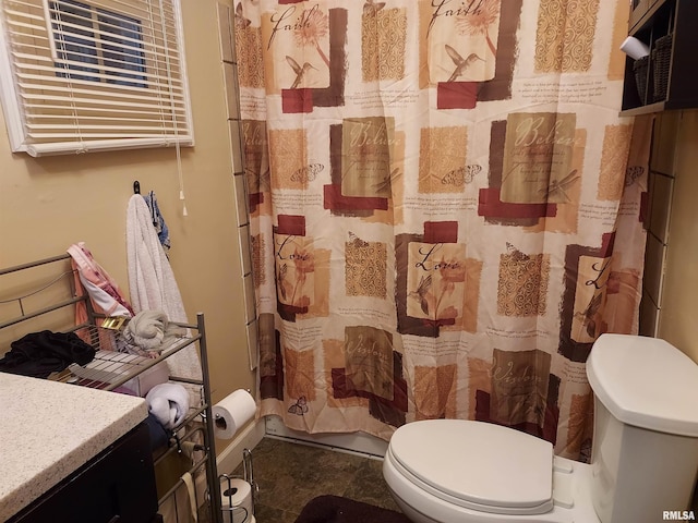 bathroom with tile flooring, vanity, and toilet