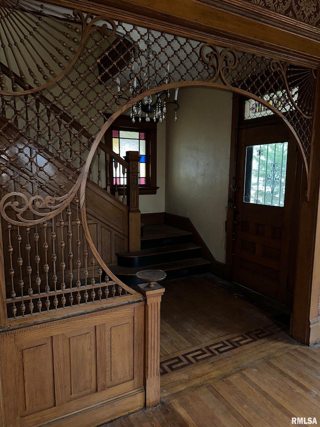 entryway featuring dark parquet flooring