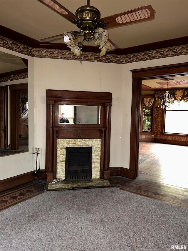 unfurnished living room featuring ceiling fan and dark colored carpet