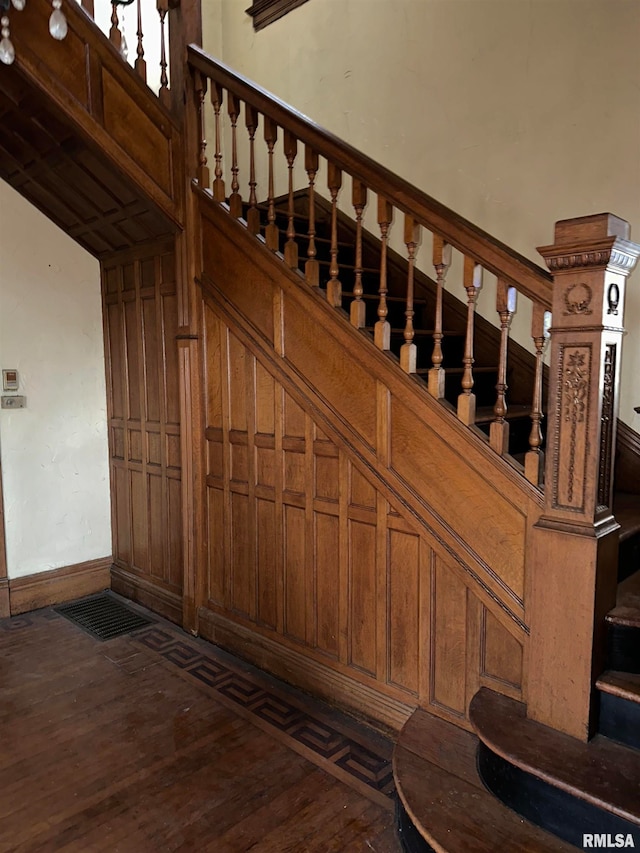 staircase with dark hardwood / wood-style flooring