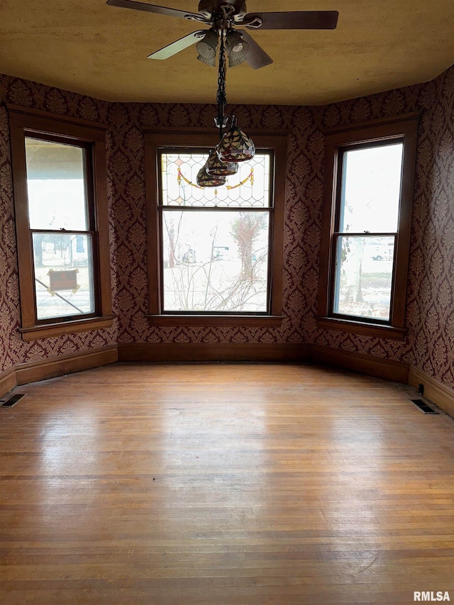 empty room featuring light hardwood / wood-style flooring and ceiling fan