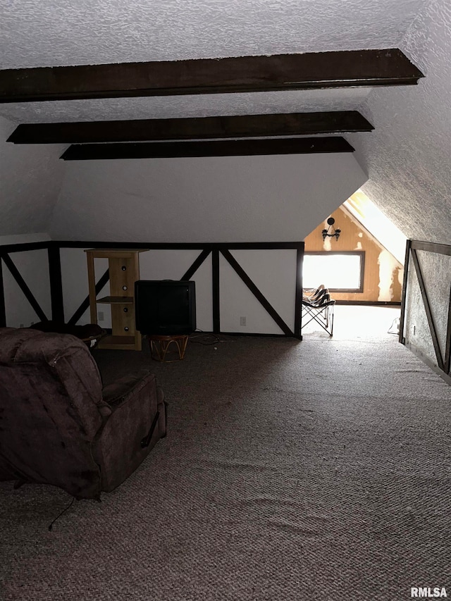 unfurnished bedroom featuring lofted ceiling, a textured ceiling, and carpet floors