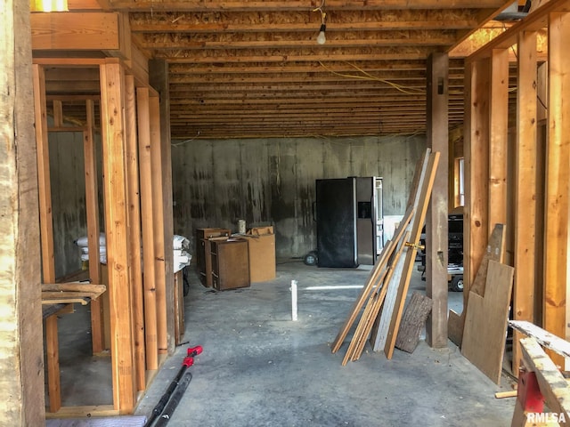 basement with stainless steel fridge with ice dispenser