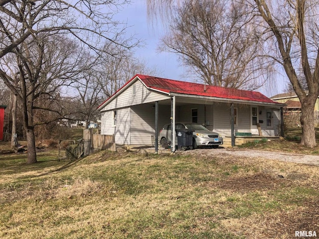 back of house featuring a carport