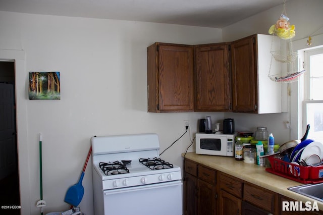 kitchen featuring white appliances and sink