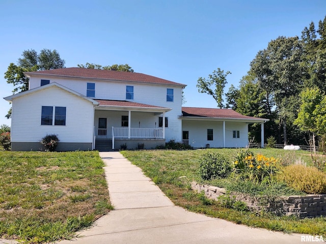 view of front of home featuring covered porch and a front lawn