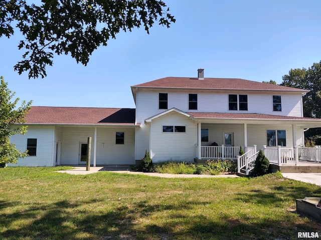 view of front of house with a porch and a front yard