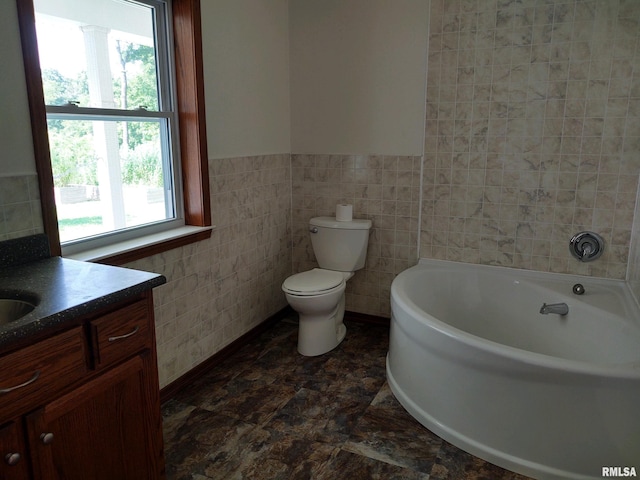 bathroom featuring tile walls, toilet, a wealth of natural light, and vanity