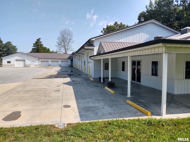 view of side of property featuring a carport and a garage