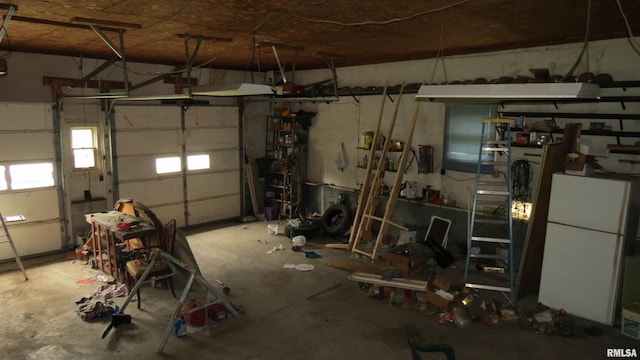 garage with a workshop area and white refrigerator