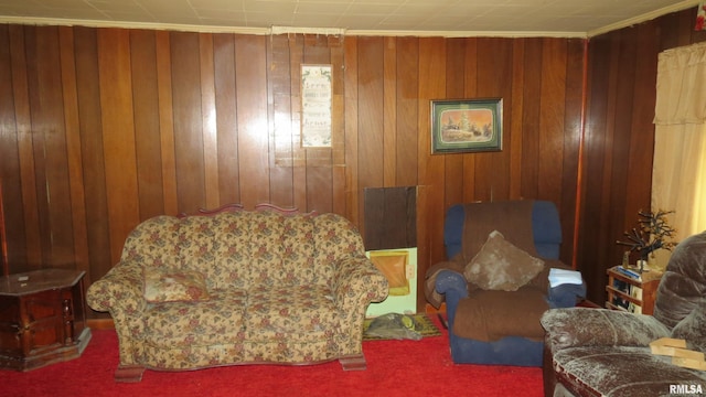 sitting room featuring ornamental molding, carpet flooring, and wood walls