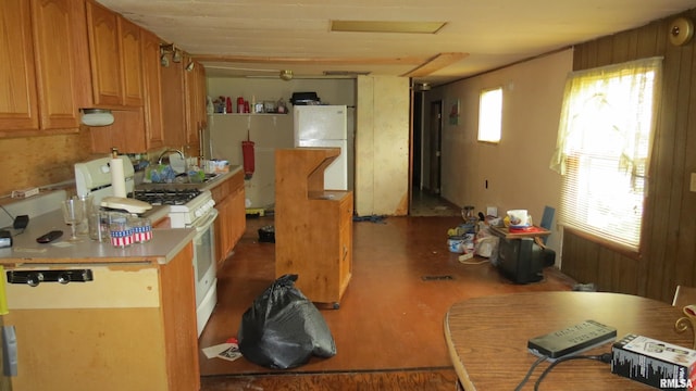 kitchen with white appliances, radiator, and sink