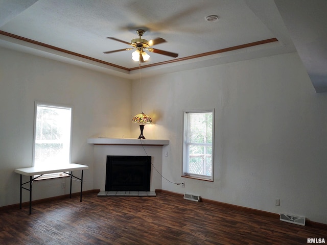 unfurnished living room featuring dark hardwood / wood-style floors, plenty of natural light, and ceiling fan