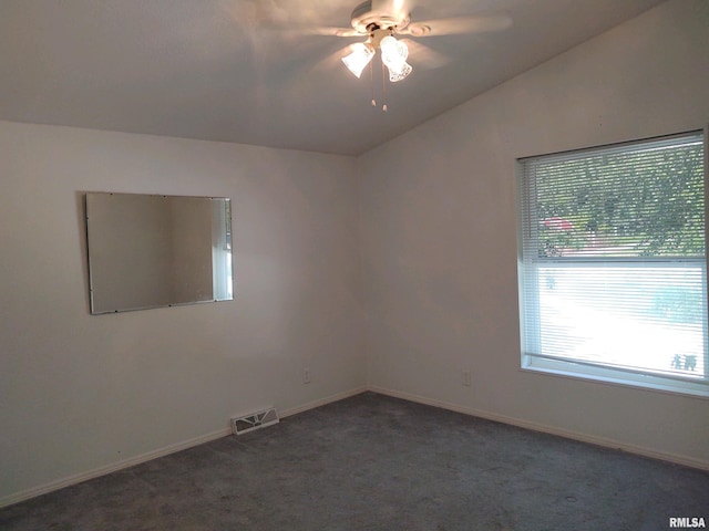 unfurnished room featuring ceiling fan, dark carpet, and vaulted ceiling