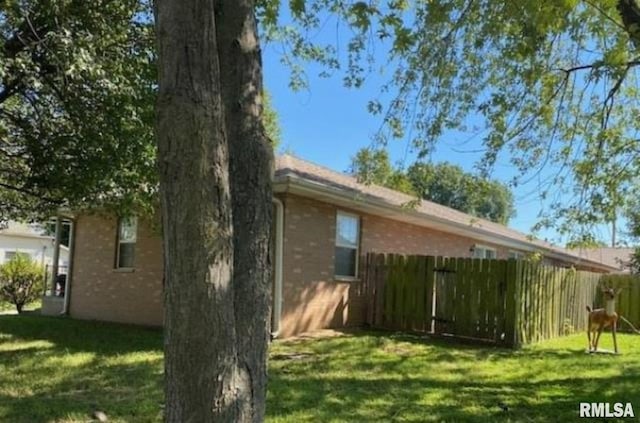 view of side of property featuring a yard