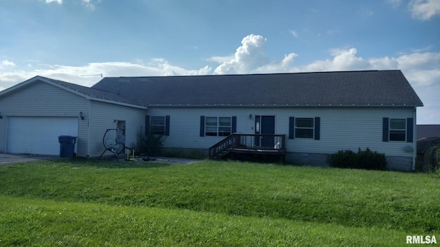 view of front of property with a front yard, a deck, and a garage