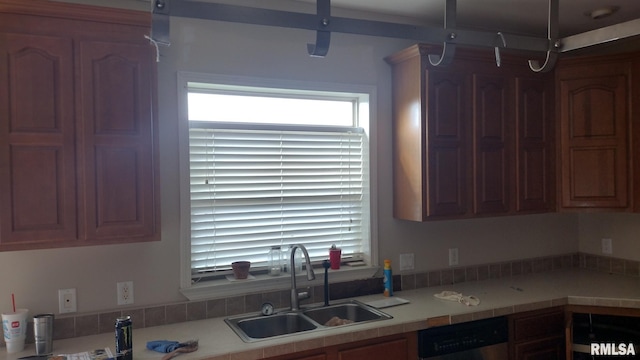 kitchen featuring light countertops, a sink, and dishwasher