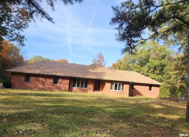 rear view of property featuring a lawn