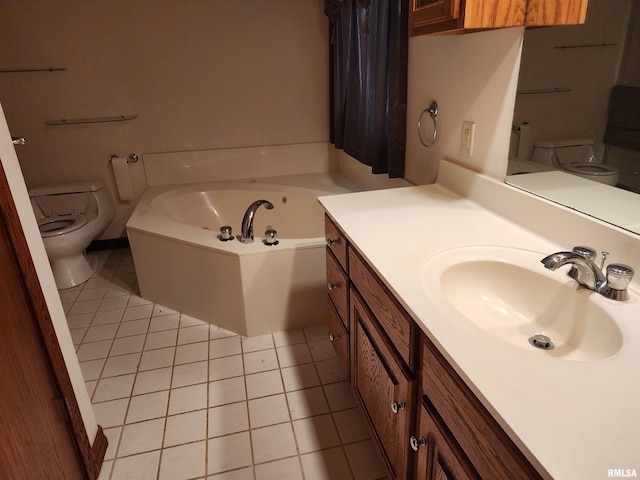 bathroom with tile patterned flooring, a tub, vanity, and toilet