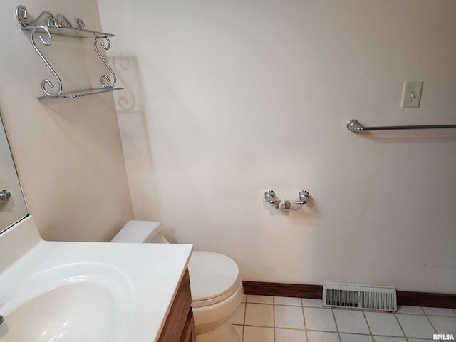 bathroom featuring toilet, vanity, and tile patterned flooring