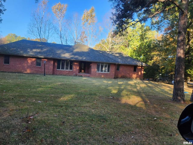 back of property featuring a lawn