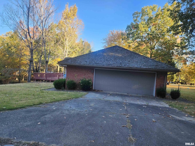 garage featuring a lawn