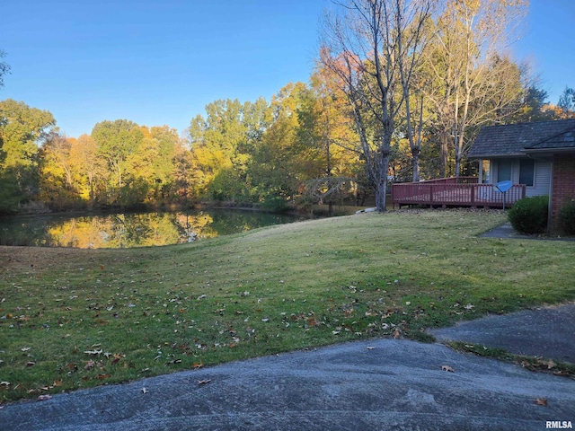 view of yard with a deck with water view