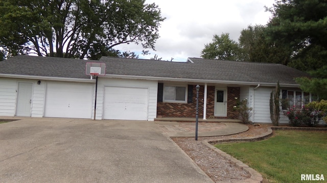 ranch-style house featuring a front yard and a garage