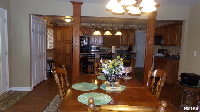 805 W Race St, Ridgway, IL 62979 - dining space featuring dark hardwood / wood-style flooring and an inviting chandelier