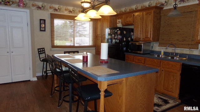 805 W Race St, Ridgway, IL 62979 - kitchen featuring a notable chandelier, decorative light fixtures, a kitchen island, black appliances, and sink