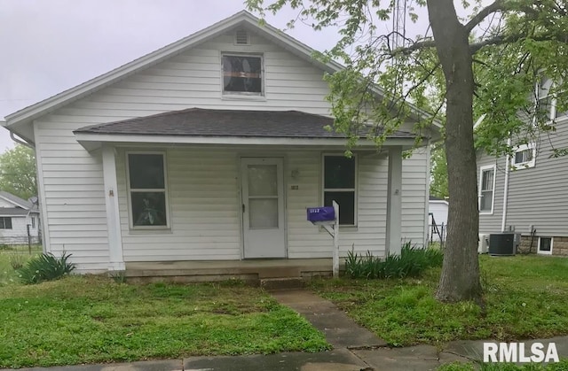 bungalow-style home with covered porch and central AC unit