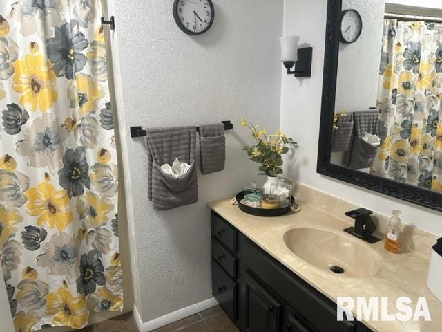 bathroom with tile floors and vanity