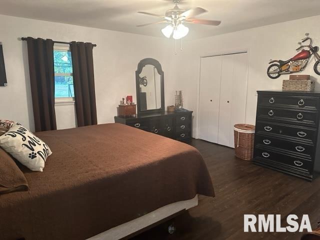 bedroom with a closet, ceiling fan, and dark hardwood / wood-style floors