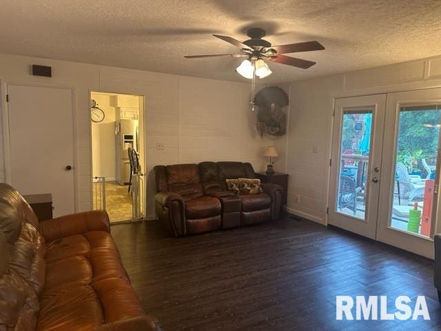 living room featuring dark hardwood / wood-style floors, french doors, ceiling fan, and a textured ceiling