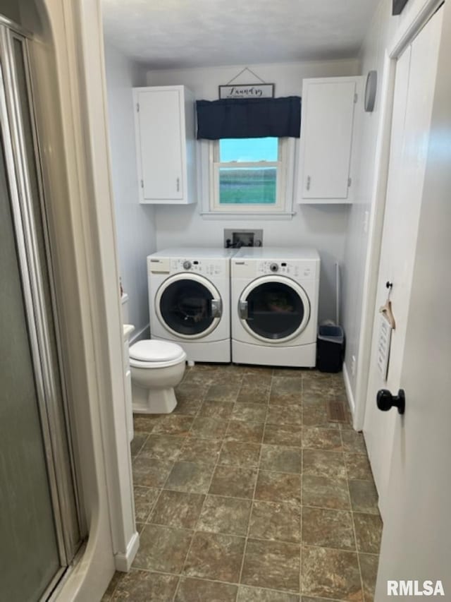 laundry room with separate washer and dryer, washer hookup, and dark tile floors