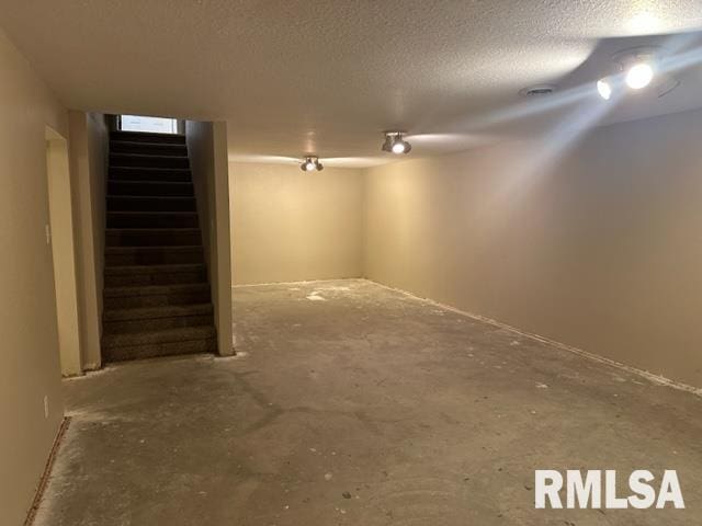 basement featuring a textured ceiling