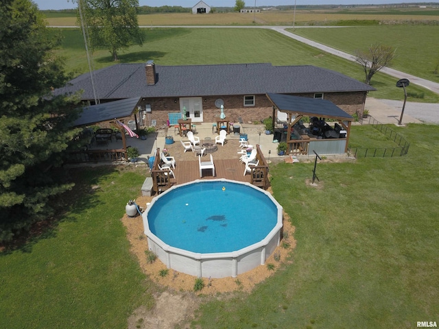 view of swimming pool featuring a gazebo, a yard, a rural view, and a patio