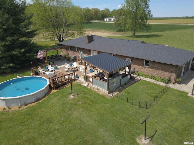 view of swimming pool with a lawn