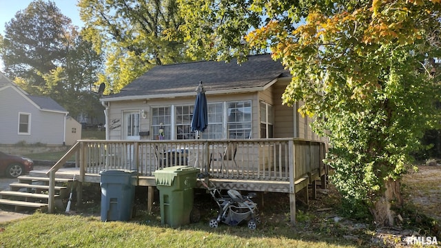 back of house with a deck