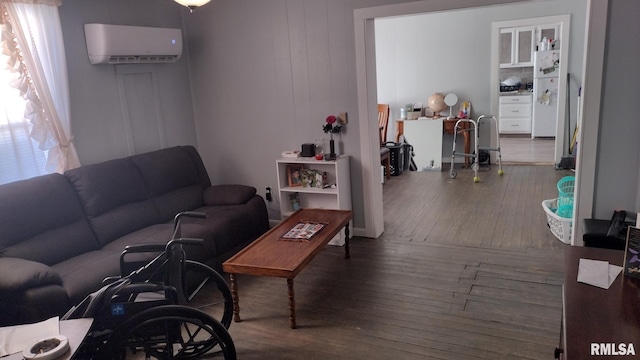 living room with a wall mounted AC and dark hardwood / wood-style floors