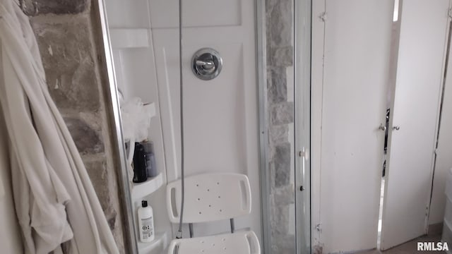 bathroom with a shower with door