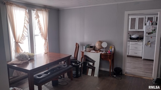 dining room featuring ornamental molding and dark hardwood / wood-style flooring